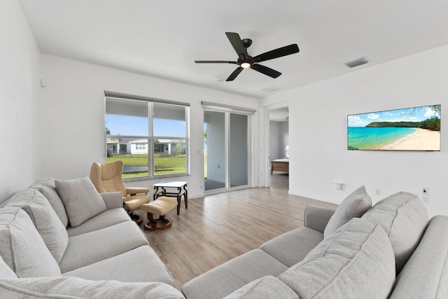 living room featuring light wood-type flooring and ceiling fan