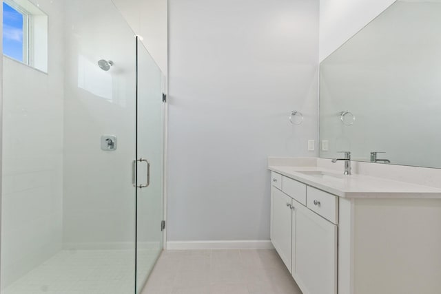 bathroom with vanity, tile patterned floors, and a shower with door