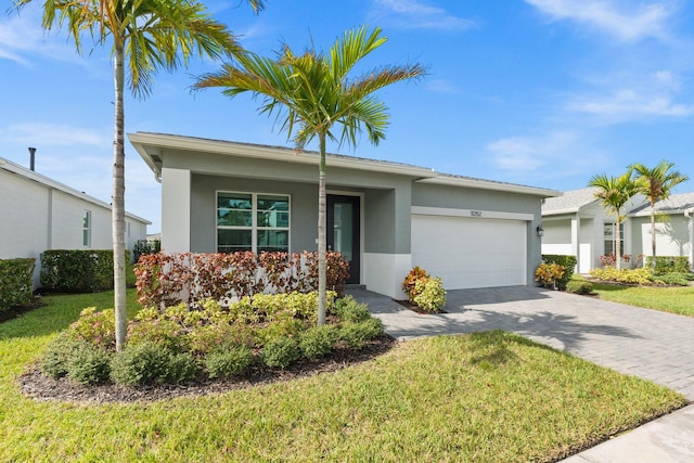 single story home with a front lawn and a garage