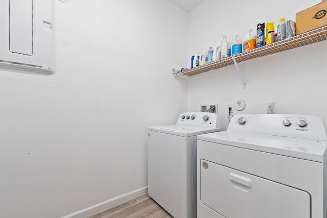 clothes washing area featuring washer and dryer and light wood-type flooring