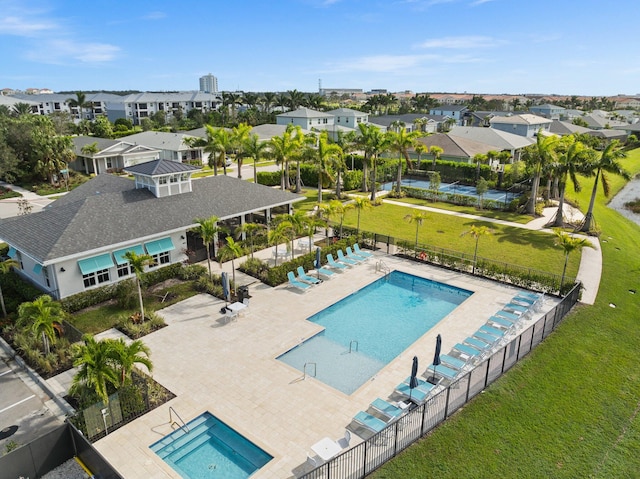 view of swimming pool featuring a patio and a lawn