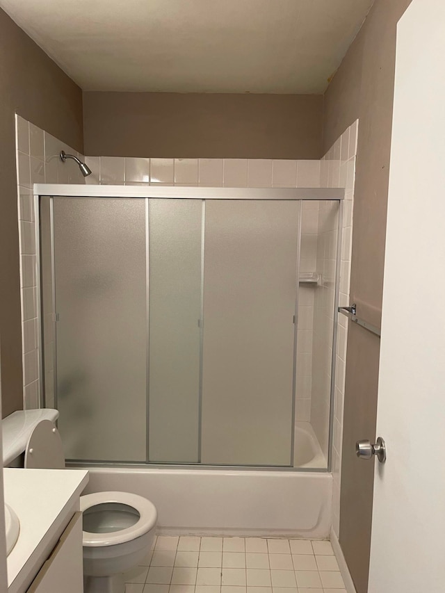 full bathroom with vanity, toilet, tile patterned floors, and enclosed tub / shower combo