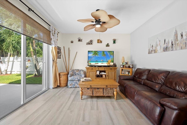 living room featuring light wood-type flooring and ceiling fan