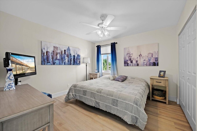 bedroom with a closet, hardwood / wood-style flooring, and ceiling fan