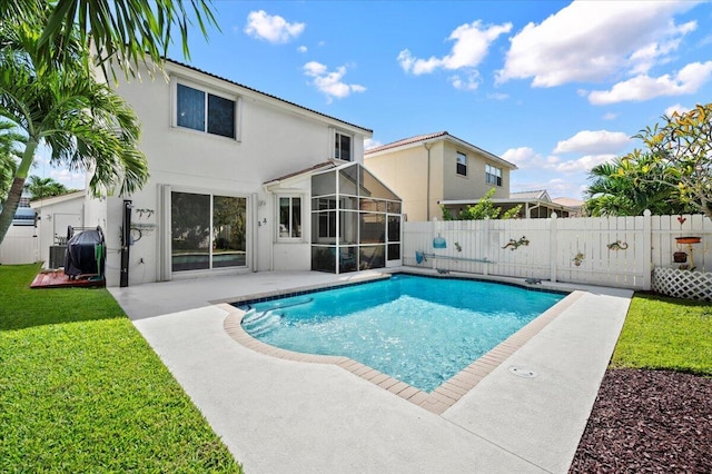 view of pool featuring a yard, a patio, and a sunroom