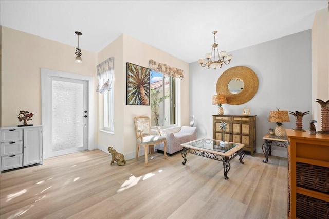 living area featuring an inviting chandelier and light wood-type flooring