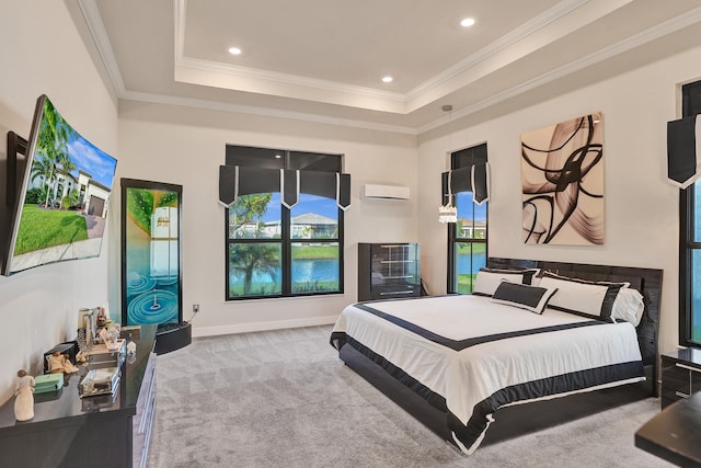 bedroom with ornamental molding, a wall unit AC, light colored carpet, and a tray ceiling