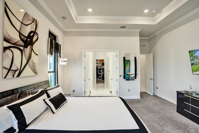 carpeted bedroom featuring ornamental molding and a tray ceiling