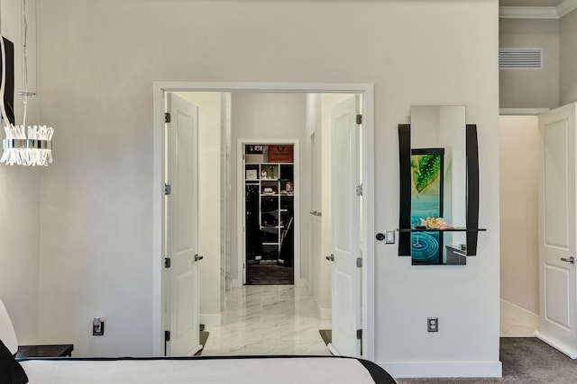 carpeted bedroom with a walk in closet