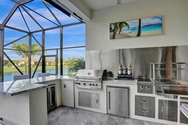 view of patio / terrace featuring a water view, area for grilling, a grill, and a lanai