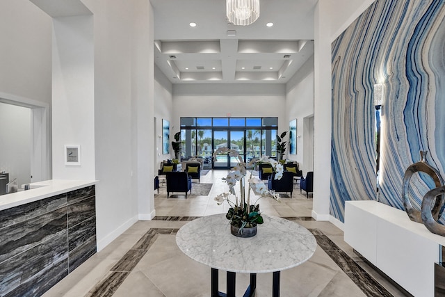 foyer entrance with a towering ceiling and a notable chandelier