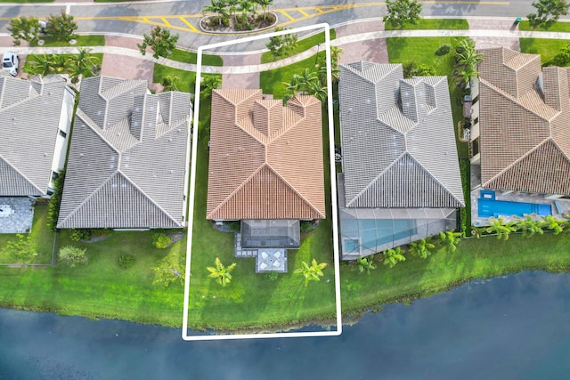 birds eye view of property with a water view