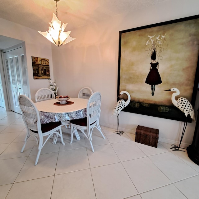 tiled dining room featuring a chandelier