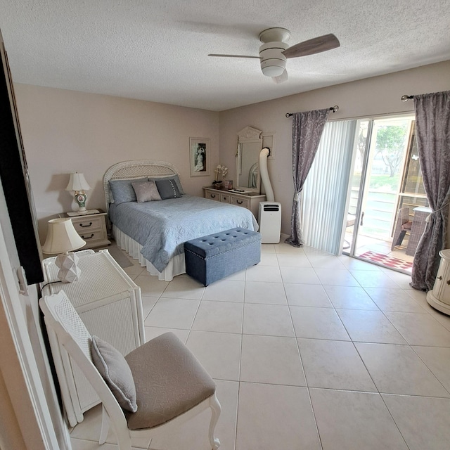 tiled bedroom featuring access to exterior, a textured ceiling, and ceiling fan