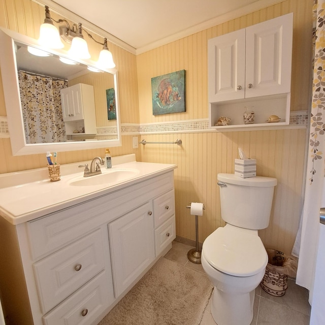 bathroom featuring vanity, ornamental molding, tile patterned floors, and toilet