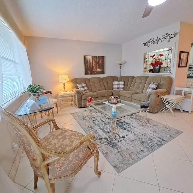 tiled living room featuring ceiling fan and a textured ceiling