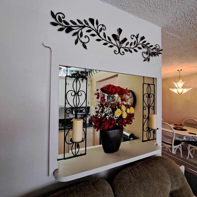 room details featuring a textured ceiling and a notable chandelier