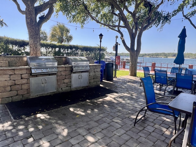 view of patio with a water view, grilling area, and area for grilling