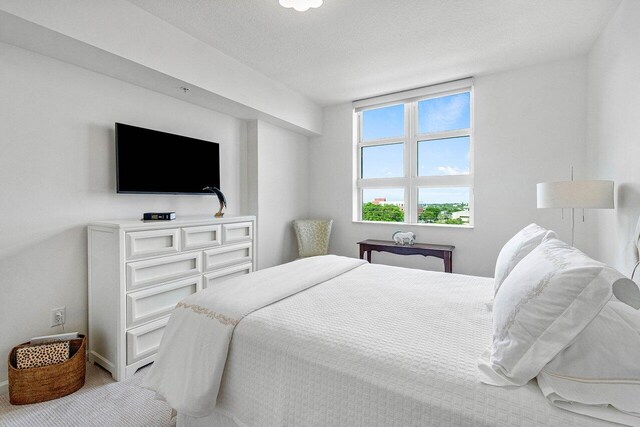 carpeted bedroom featuring a textured ceiling