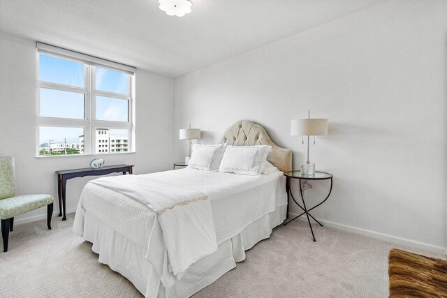 bedroom featuring light colored carpet