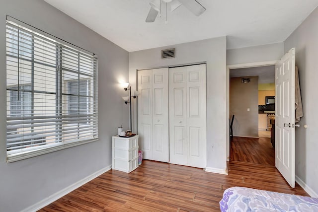 unfurnished bedroom with a closet, ceiling fan, and wood-type flooring