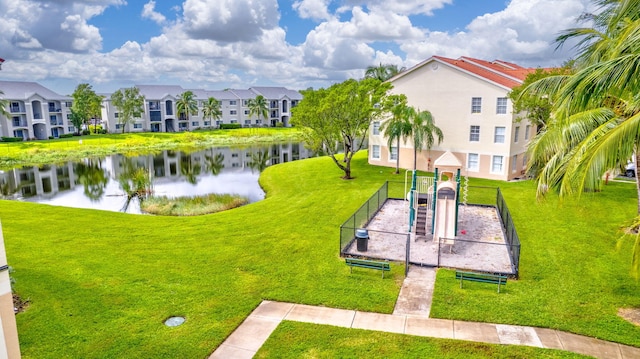 view of home's community featuring a water view and a lawn