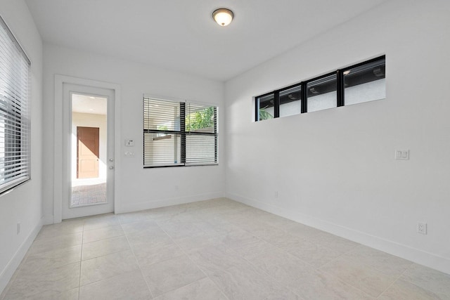 unfurnished room featuring light tile patterned flooring