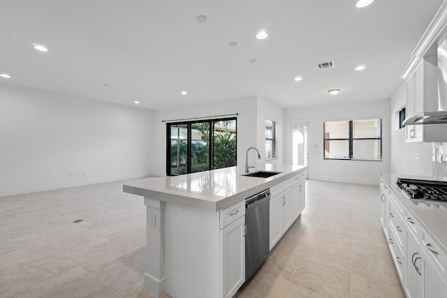 kitchen with a center island with sink, sink, white cabinets, and stainless steel appliances