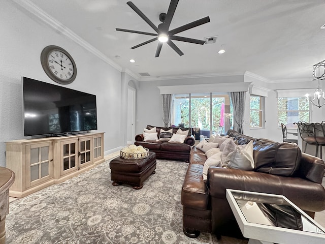 living room featuring ornamental molding and ceiling fan with notable chandelier