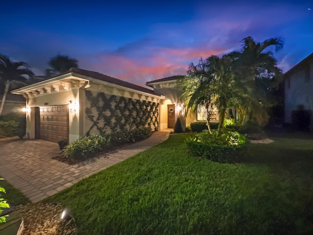 view of front of house featuring a yard and a garage