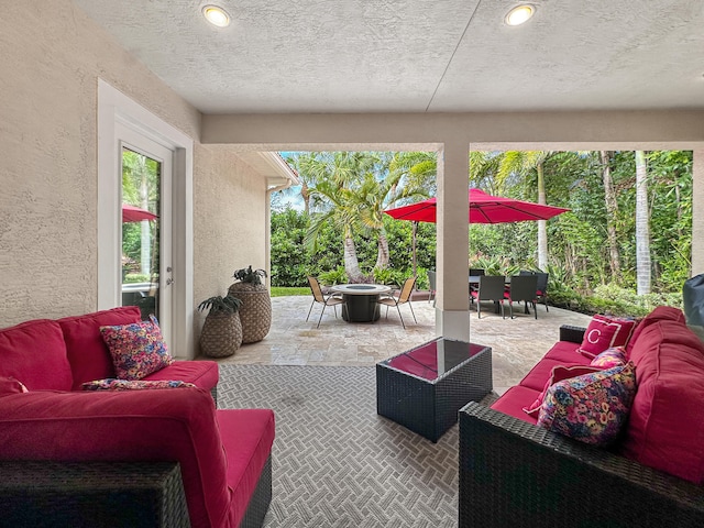 view of patio featuring an outdoor living space with a fire pit