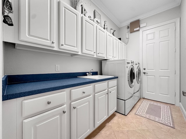 laundry area featuring light tile patterned floors, ornamental molding, sink, cabinets, and washing machine and clothes dryer