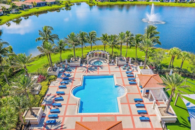 view of swimming pool with a patio and a water view