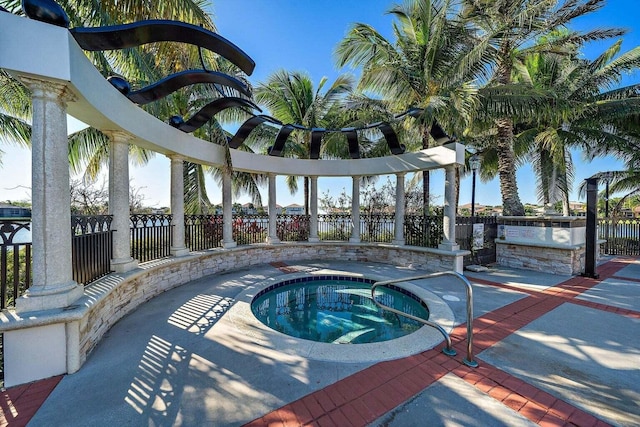 view of swimming pool with exterior kitchen and an in ground hot tub