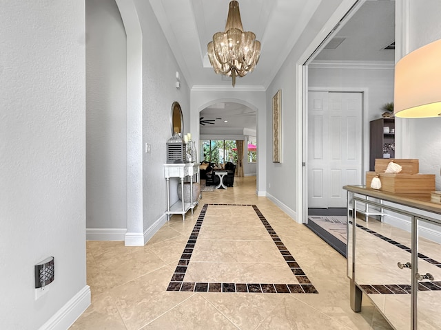 foyer with tile patterned floors, crown molding, and ceiling fan with notable chandelier