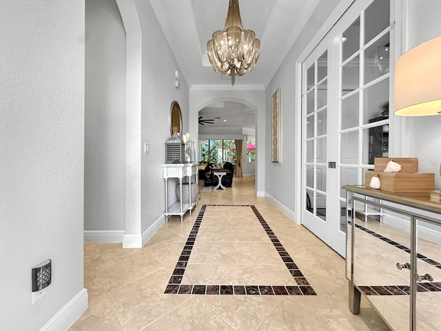 hall with crown molding, tile patterned floors, and an inviting chandelier