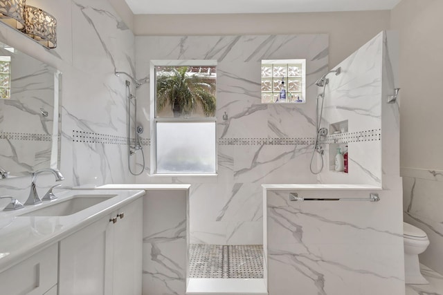 bathroom with vanity, toilet, tile walls, and tiled shower