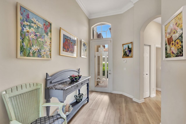 entryway featuring crown molding, radiator, and light wood-type flooring