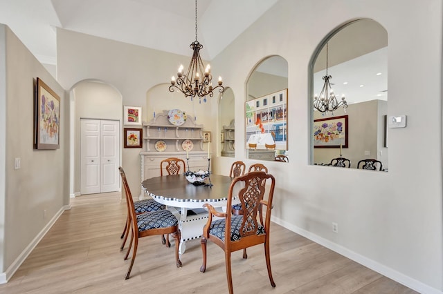 dining room featuring light hardwood / wood-style floors and a chandelier