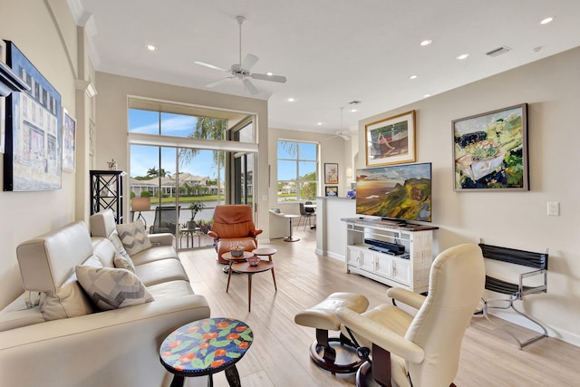 living room featuring light wood-type flooring and ceiling fan