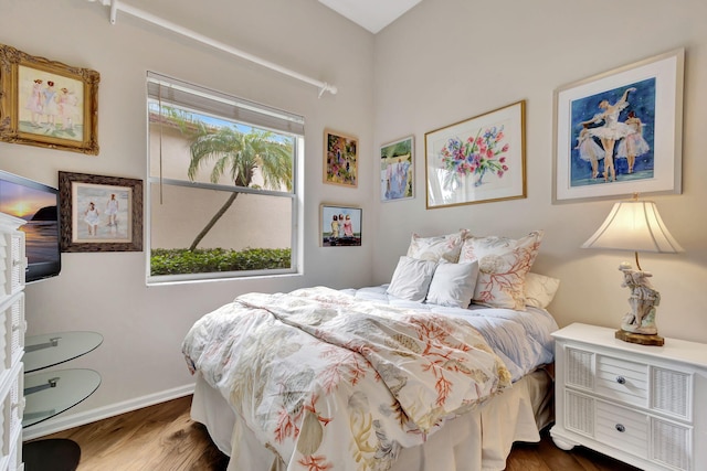 bedroom with dark hardwood / wood-style floors