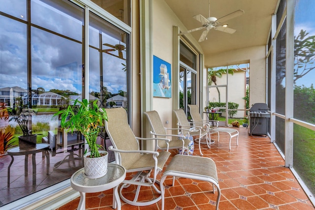 sunroom / solarium featuring ceiling fan