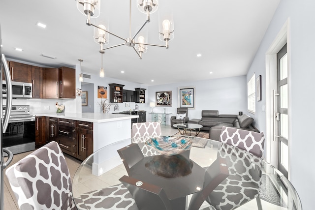 dining area with a notable chandelier and light tile patterned floors