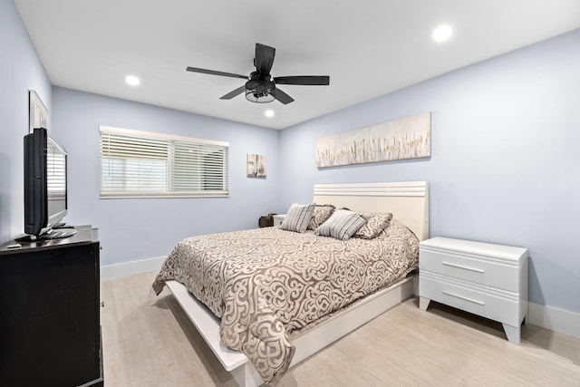 bedroom with light hardwood / wood-style flooring and ceiling fan