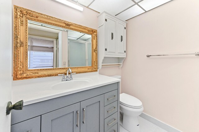 bathroom featuring toilet, vanity, and tile patterned floors