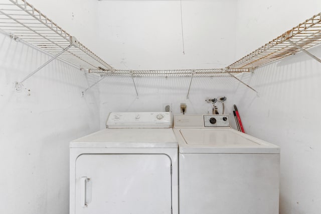 clothes washing area with washer and clothes dryer