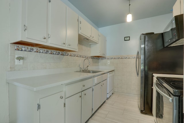 kitchen with white cabinets, white dishwasher, stainless steel electric stove, sink, and tile walls