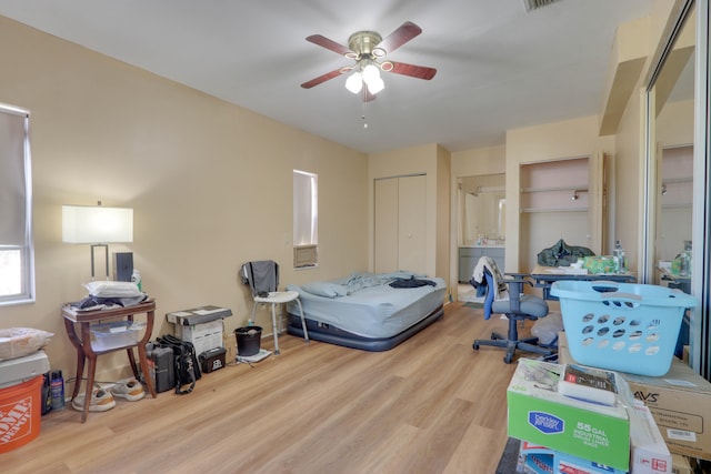 bedroom with light wood-type flooring, a closet, and ceiling fan