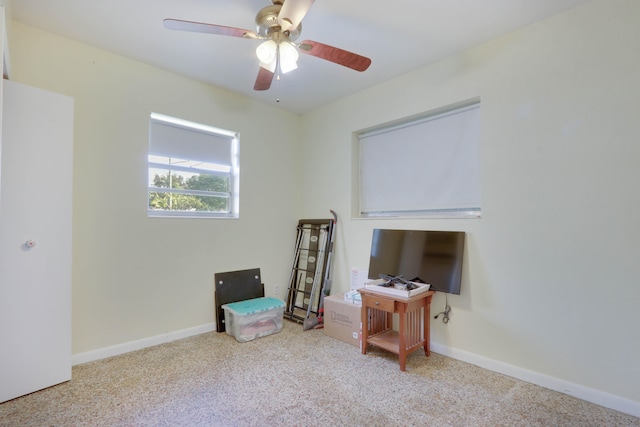 interior space featuring ceiling fan and light colored carpet