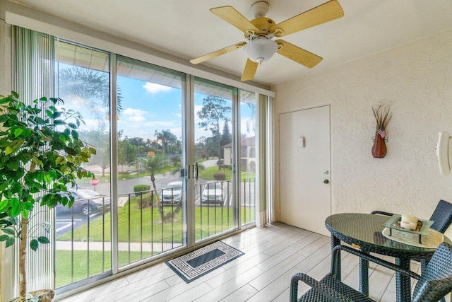 entryway with light wood-type flooring, a healthy amount of sunlight, and ceiling fan